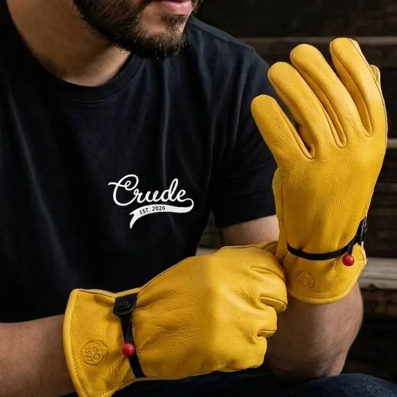 Man wearing yellow leather work gloves with wrist straps manufactured by handy gear gloves