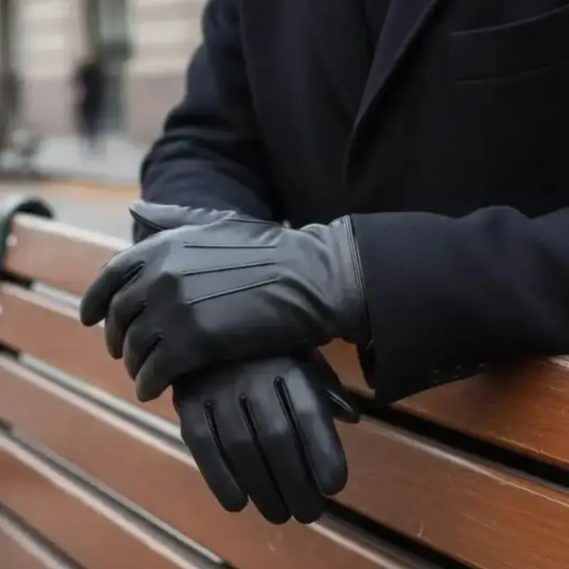 Man wearing stylish black leather gloves beside a wooden bench
